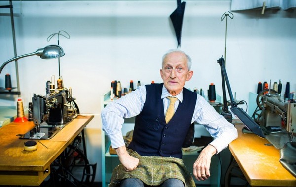 well-dressed man sitting in sewing shop