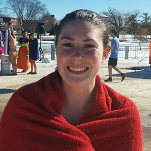 Woman wrapped in towel after doing the polar plunge in Wisconsin