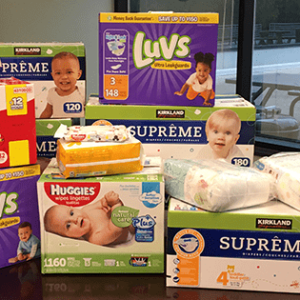 Diapers and other baby items on a table for donation