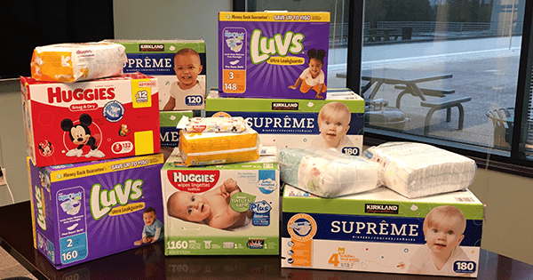 Diapers and other baby items on a table for donation