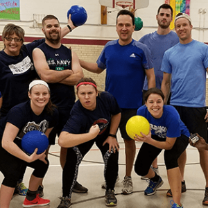 Coworkers posing for a picture before playing dodgeball together