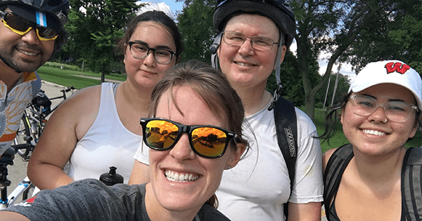 coworkers smiling in a selfie at the bike ride