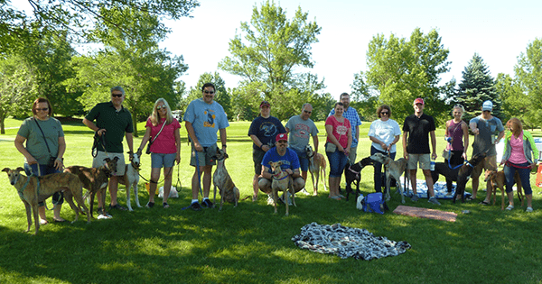 Coworkers gathered for a picture during the golfing for greyhounds event