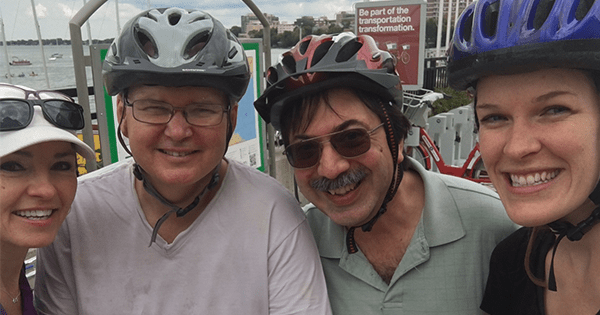 Co workers smiling in a selfie during a bike race