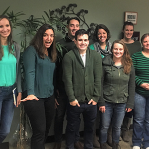 Coworkers standing together wearing green for the green light project