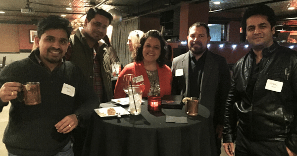 coworkers enjoying each others company at a holiday party in Des Moines