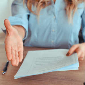 woman holding resume extending hand for a handshake