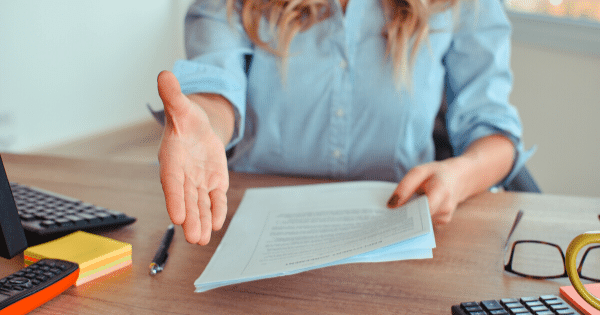 woman holding resume extending hand for a handshake
