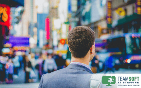 picture of man from behind walking through the city