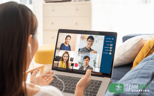 female employee in virtual meeting with coworkers on a laptop