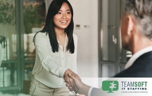 Female employee shaking hands with boss