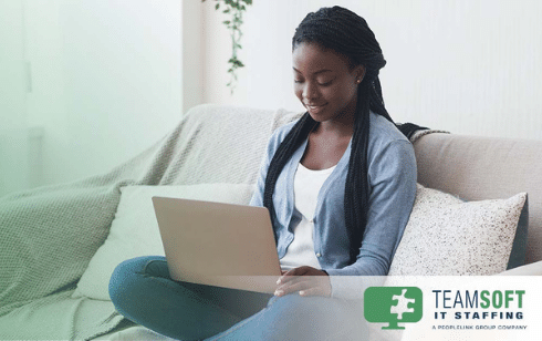 women sitting alone on couch on a laptop