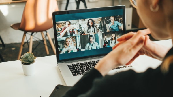 Employee on virtual meeting with coworkers