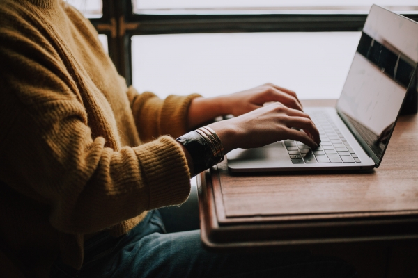 employee typing on a laptop