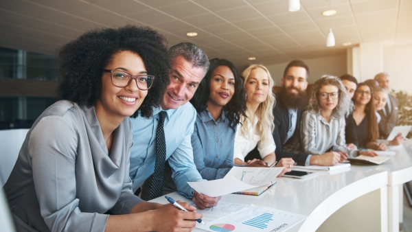 Coworkers lined up smiling at camera