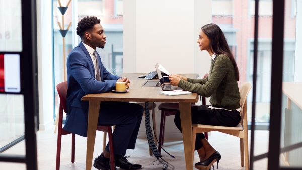 Man in a blue suit interviewing for a job