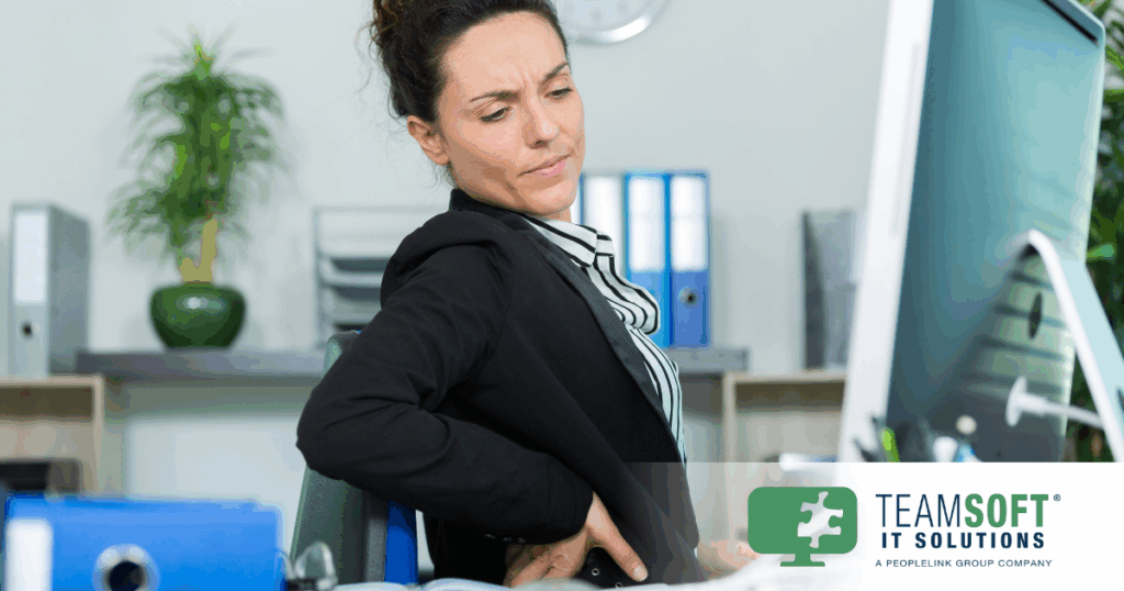 Technology professional experiencing back pain from prolonged sitting.